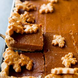 pumpkin slab pie with a slice on a dessert server