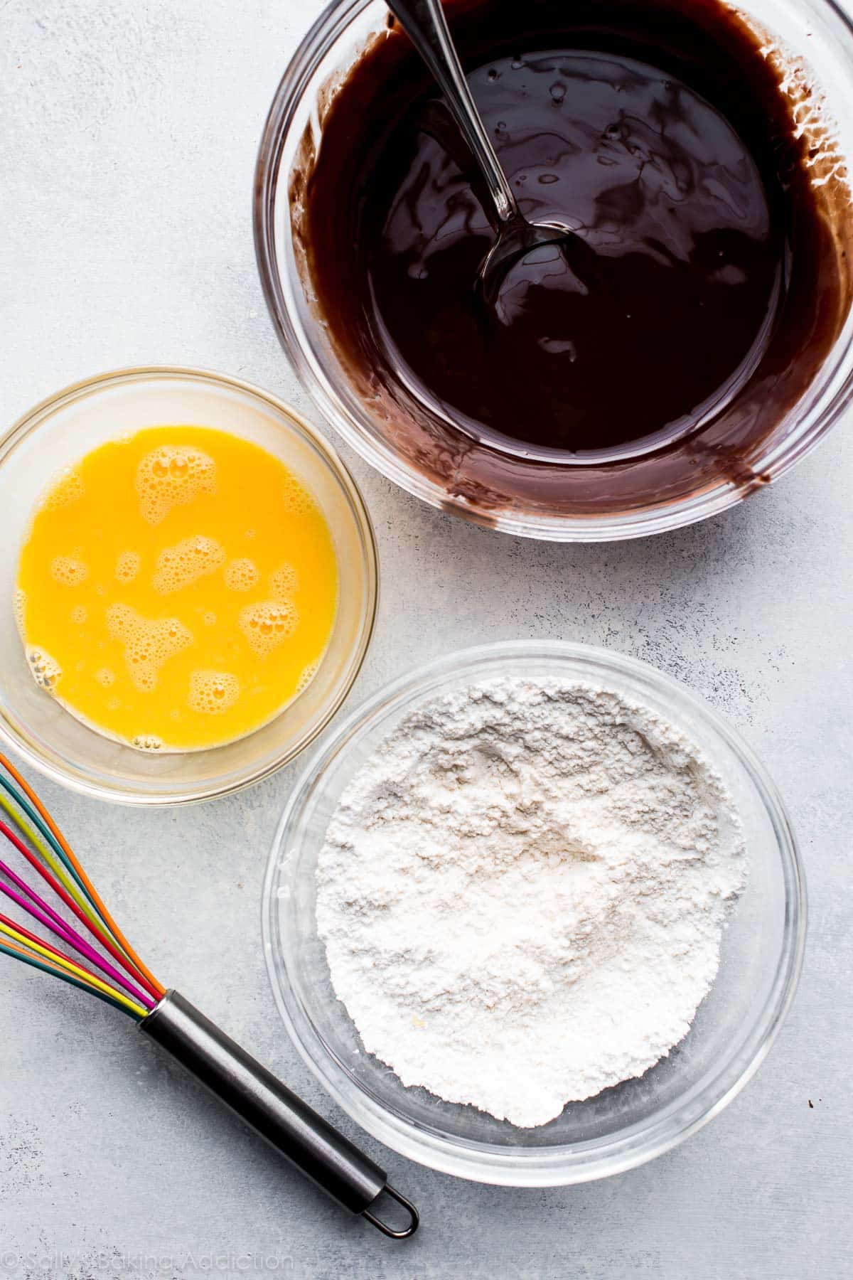 overhead image of 3 glass bowls of ingredients for chocolate lava cakes