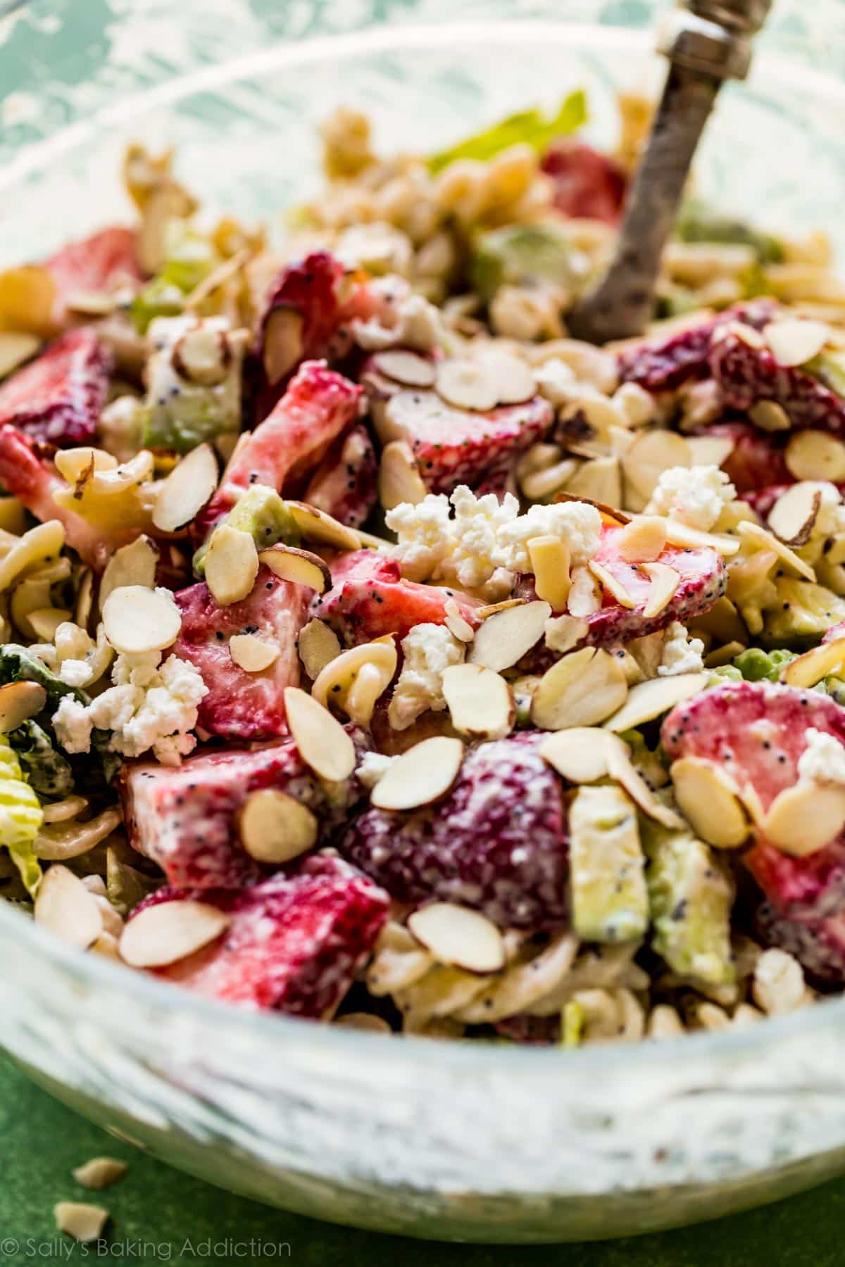 strawberry feta pasta salad in a glass bowl