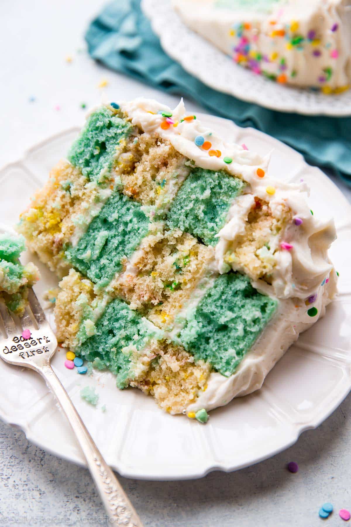 slice of checkerboard cake on a white plate with a fork