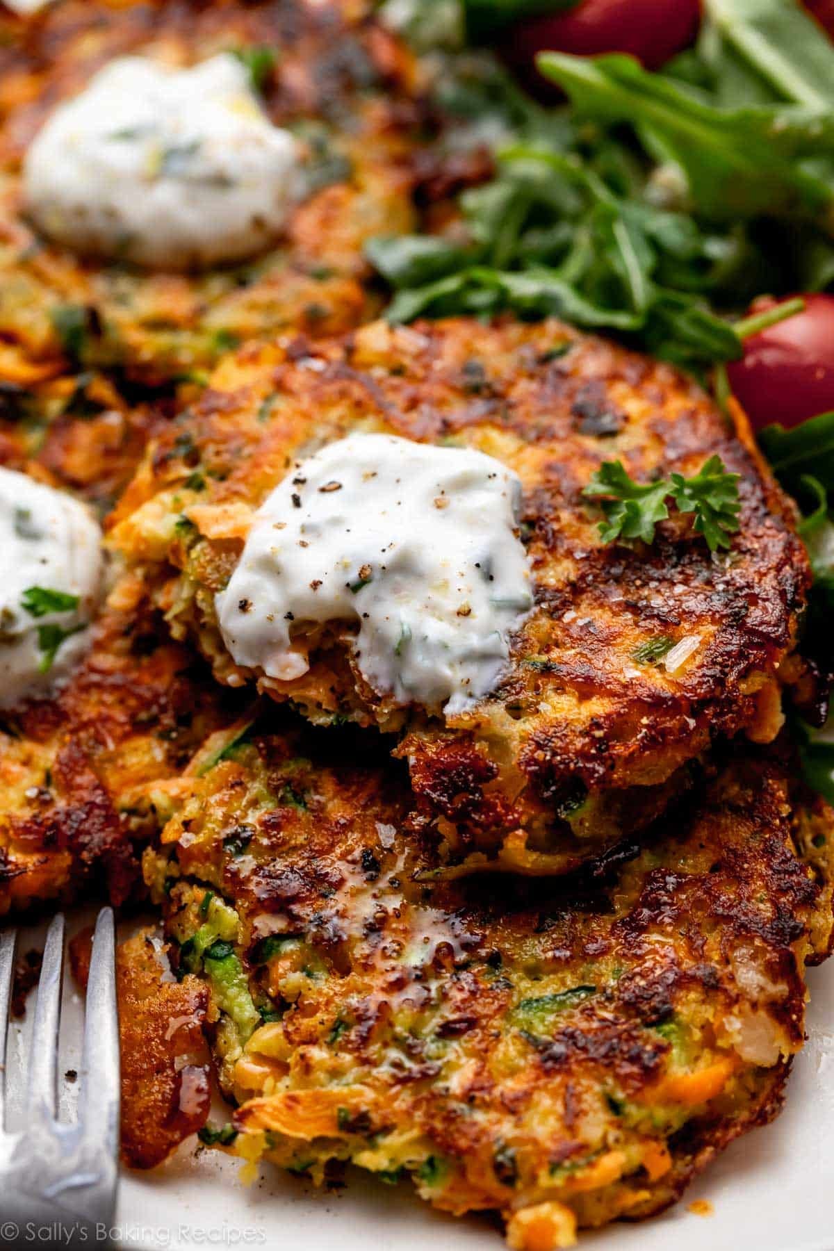sweet potato zucchini fritter with forkful removed.