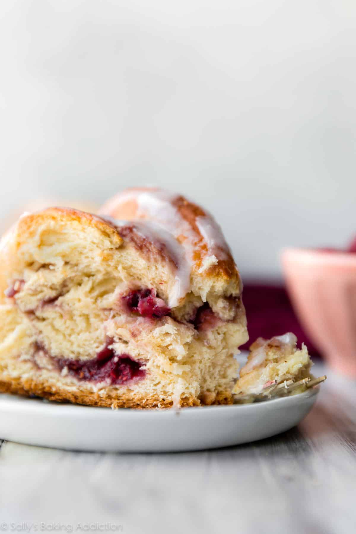 slice of raspberry danish twist on white plate