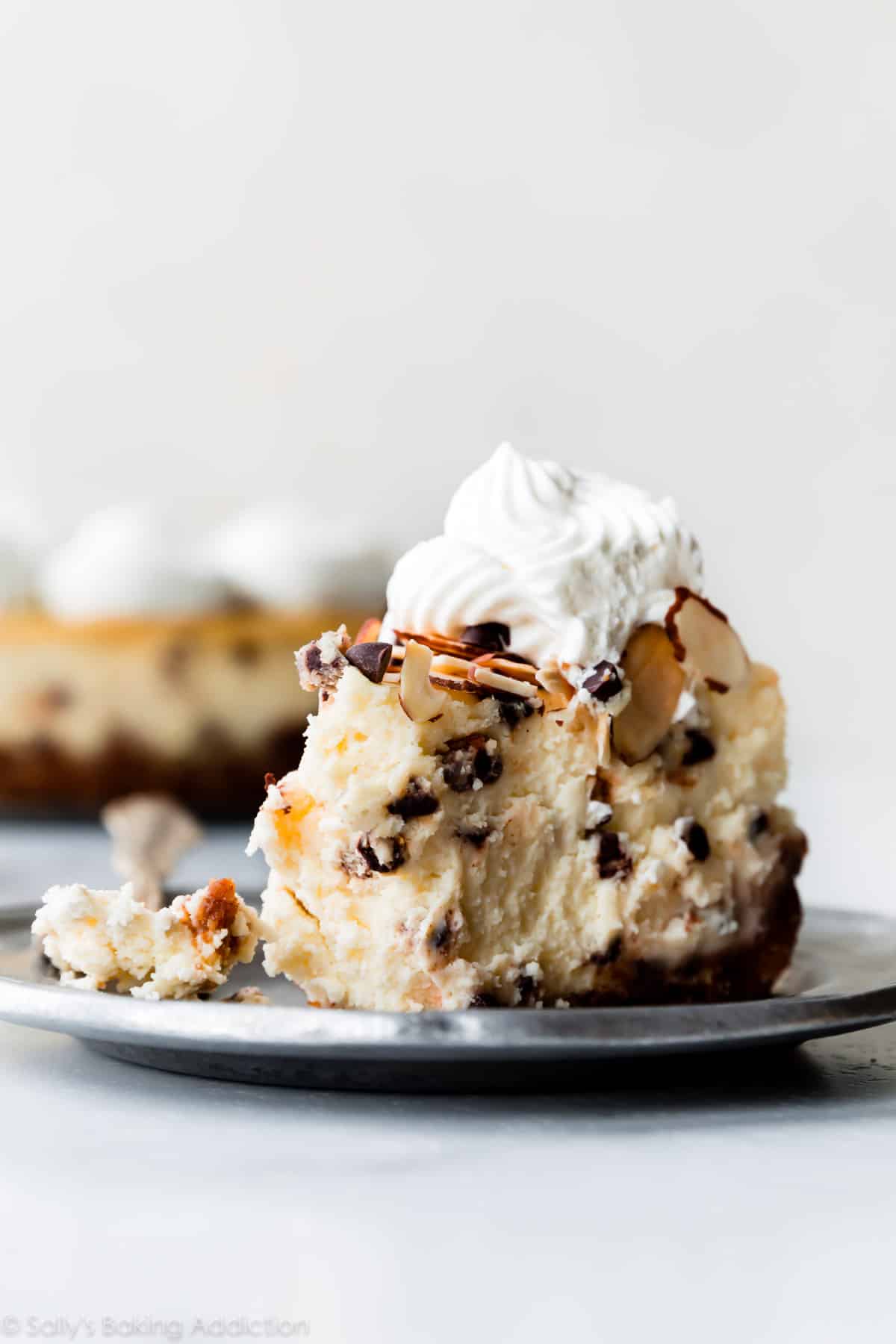 Slice of amaretto cheesecake on a silver plate