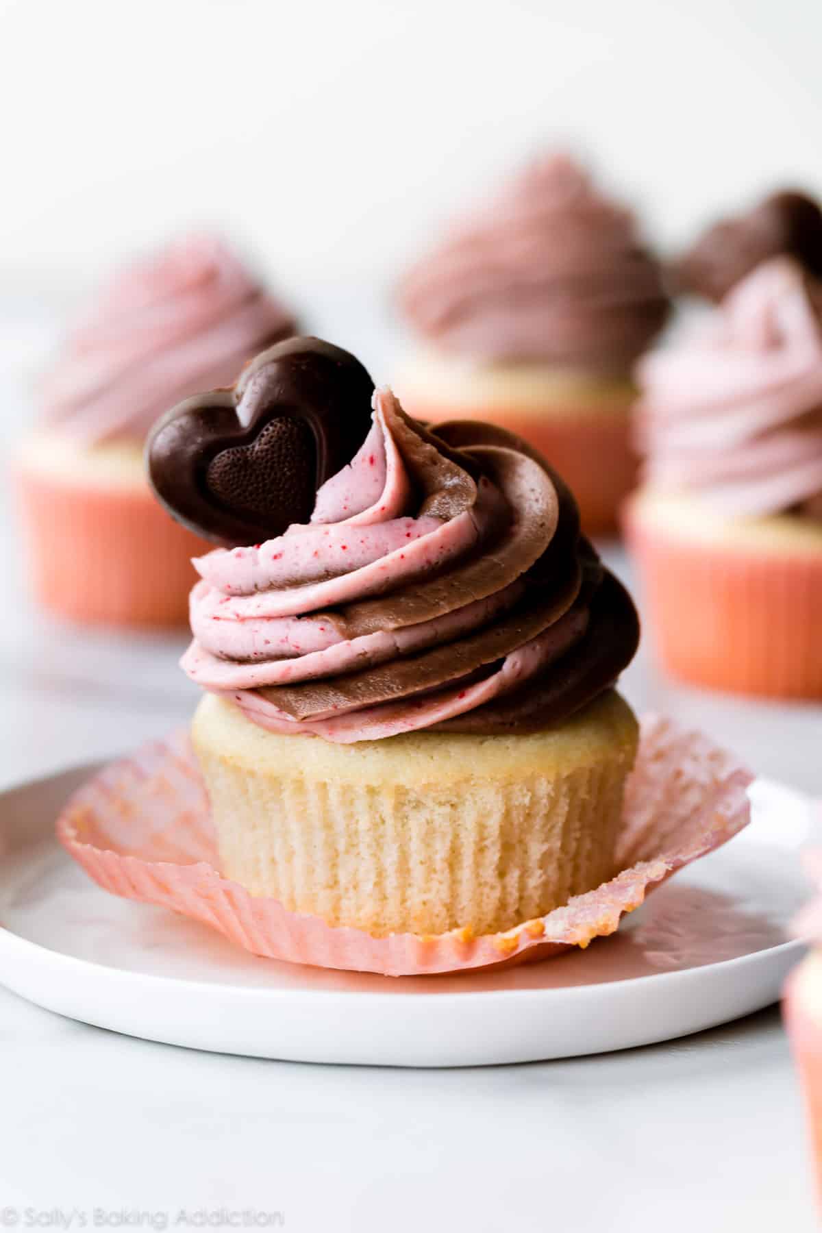 strawberry nutella cupcake on a white plate with a chocolate heart on top