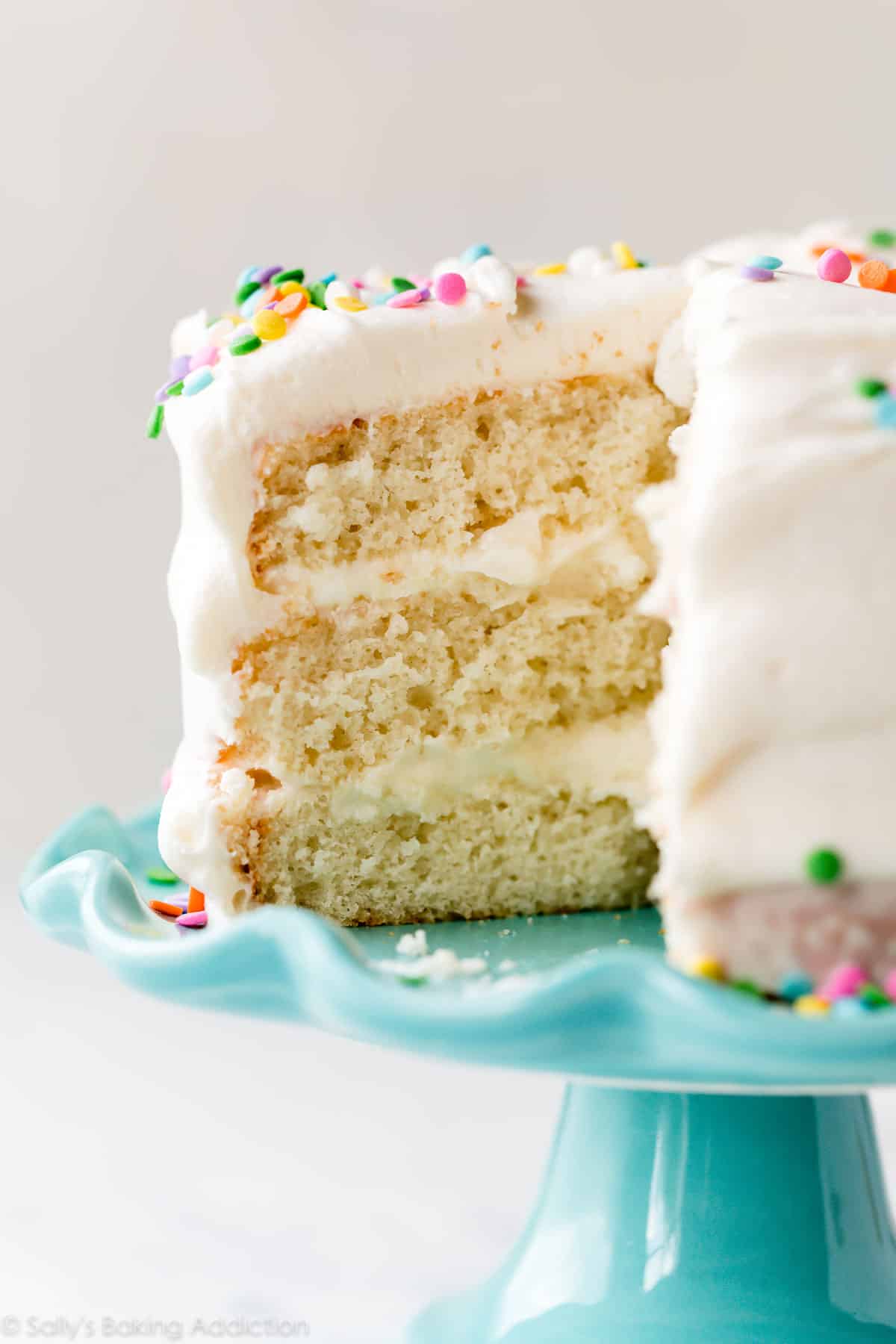 6 inch vanilla cake with sprinkles on teal cake stand
