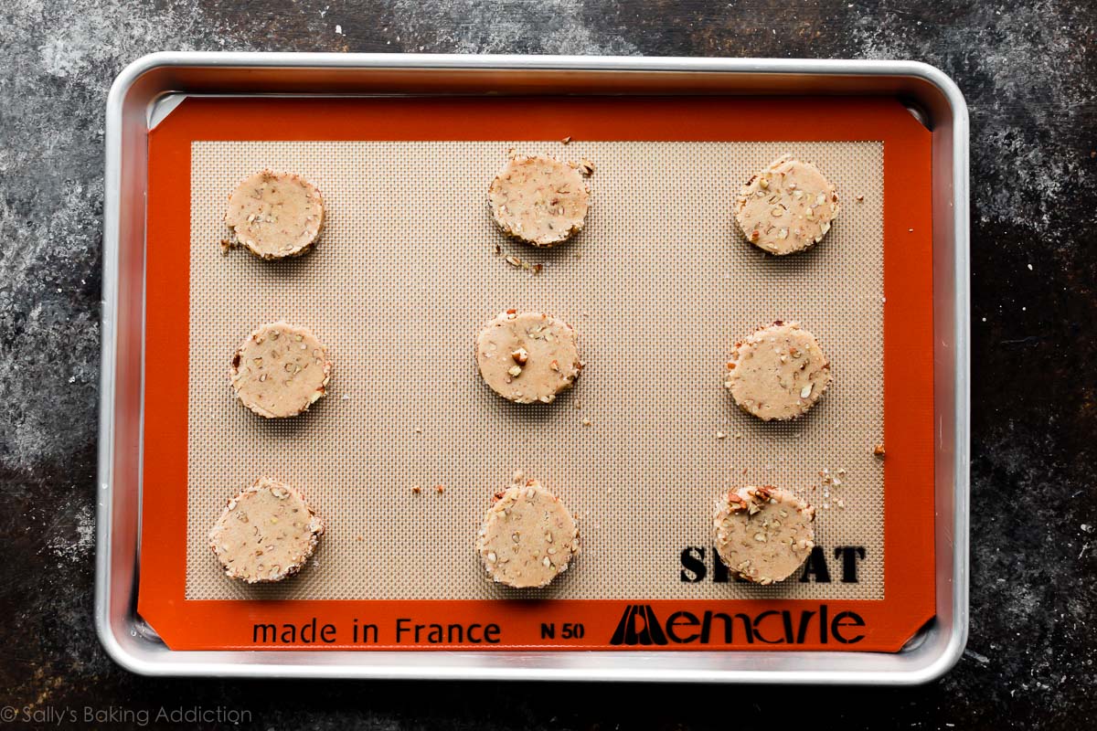 sliced pecan shortbread cookie dough on a baking sheet