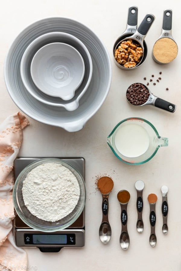 measuring spoons and cups and a food scale with ingredients.