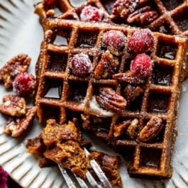 fork removing bite of gingerbread waffles.
